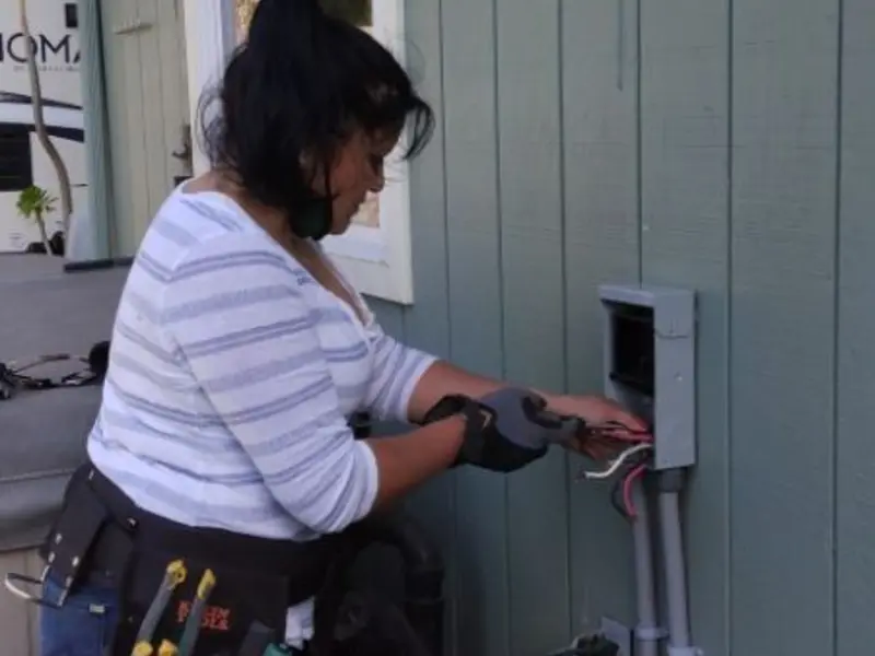 Licensed electrician wiring an exterior subpanel in Scriba