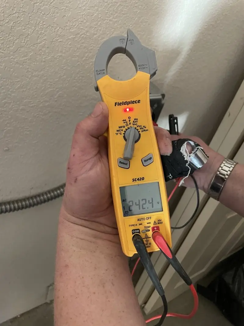 Voltage testing with clamp meter during Electrical Installation Services in Scriba